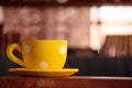 Close up of dotted yellow cup on the table