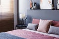 Close-up of a double bed decorated with pillows in a hotel room