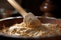 close-up of dough being mixed with wooden spoon