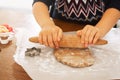 A close up dough.Child hands using rolling spin for gingerbread cookies. Christmas family traditions. Leisure of the Royalty Free Stock Photo