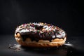 Close-up of a doughnut with glaze over a black background. display, overall, and lateral views. complete view.