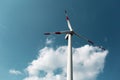 Close-up down view of wind turbine on background of blue sky. Windmill generating green energy. Royalty Free Stock Photo