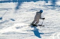 Close up of a downhill skier speeding down a mountain with a trail of snow