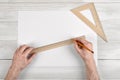 Close-up of draftsman hands holding centimeter ruler and pencil. Measuring process.