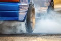 Drag racing car burns rubber off its tires in preparation for the race Royalty Free Stock Photo