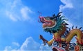 Close-up dragon statue from roof top of Chinese Temple on blue sky background Royalty Free Stock Photo