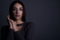 Close-up dramatic beauty portrait of a beautiful young girl of twenty years. With natural makeup. Holds hands by the face. On a Royalty Free Stock Photo