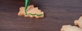 Close up of drawing Christmas tree sugar cookie on wooden table background with icing Royalty Free Stock Photo