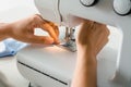 Close up dressmaker is process electric sewing machine with fabric and thread ,starting for tailor business.