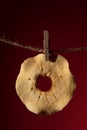 Close-up of a dried apple on a rope.