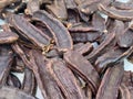 Close-up of dried carob pods piled together Royalty Free Stock Photo