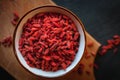 Close-up of dried goji berries in a bowl on dark background, top view Royalty Free Stock Photo