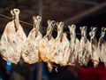 Close up dried squid hanging with clip in a line. Sun dried cuttlefish, street food in Thailand.