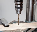 Close up of drill bit above wood