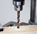 Close up of drill bit above wood