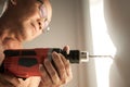 Close up drill, Old man using a drilling power tool