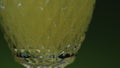 Close-up of drink being poured into transparent glass. Stock clip. Green alcoholic drink is poured into glass. Club
