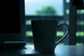 Close up drink cup and laptop on desk in home at morning time Royalty Free Stock Photo