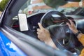 Close Up Of Driver With Hands Free Unit For Green Screen Mobile Phone Mounted On Dashboard