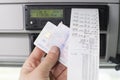 Close up of a driver holding printed day shift in focus together with drivers licence and digital tachograph card .