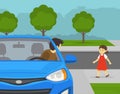 Close-up of a driver looks back before moving reverse in the driveway. Little girl walks behind the parked car. Royalty Free Stock Photo