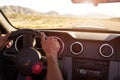 Close Up Of Driver's Hands On Car Steering Wheel