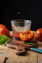 Close-up of drop of blood orange juice on transparent glass, table, blue knife, oranges and mint. On rustic table, Royalty Free Stock Photo