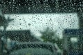 Close up of drops of rain water running down clear glass window. Rain, bad weather concept. Royalty Free Stock Photo