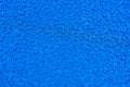 Close-up of drops of rainwater on blue metal background