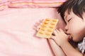 Little Asian Boy Sleep with Medicine panel in hand. Royalty Free Stock Photo
