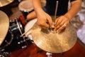 close up of a drummer& x27;s hand setting up hi-hat clutch cymbals before use