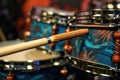 close-up of drumsticks on a custom drum set