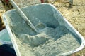 dry cement, shovel taken from a wheelbarrow for construction concrete work