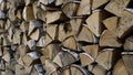 Close up of dry chopped tree trunks are laid in rows. Media. Stacked firewood prepared for the fireplace and stove. Royalty Free Stock Photo