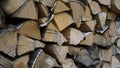 Close up of dry chopped tree trunks are laid in rows. Media. Stacked firewood prepared for the fireplace and stove. Royalty Free Stock Photo
