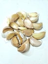 A close-up of dry garlic against a pristine white backdrop, showcasing its natural beauty and culinary potential.