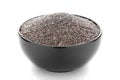 Close-up of dry organic chia seed salvia hispanica in a black ceramic bowl over white background