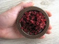 dry red barberry in a male hand