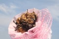 close up dry rose pink bouquet on blue sky background