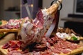 Close up on dry Spanish ham, Jamon Serrano, Bellota, Italian Prosciutto Crudo or Parma ham, whole leg on a holiday table. Royalty Free Stock Photo