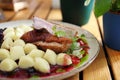 Duck breast served with kopytka, Polish potato dumplings, glazed beetroot and blackcurrant emulsion, selective focus. Royalty Free Stock Photo