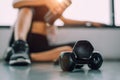 Close up of dumbbell with exercise woman lifestyle workout in gym fitness breaking relax after sport training with protein shake