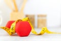 Close up dumbbell and tape measure. Healthy snack for diet planning. Royalty Free Stock Photo