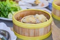 Close up dumpling Dim sum in the steam basket. Delicious chinese snack. Steaming minced pork with jelly fish on restaurant