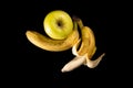 Duo of banana and apple, on a black background Royalty Free Stock Photo