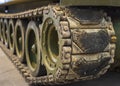 Close-up of dusty caterpillar wheels of military tank Royalty Free Stock Photo