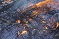 Close up of a dying fire with flames and embers.