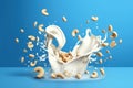 Close up of dynamic splashes of cashew milk and flying nuts on a bright blue background