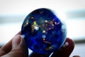 Close up of Earth at night was holding in human hands for Earth day and Energy saving concept,