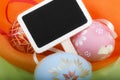 Close-up of Easter eggs and blackboard on colourful velvet Royalty Free Stock Photo